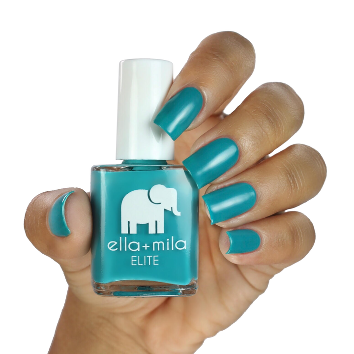One Way Ticket summertime teal nail polish on a medium skin tone, hand holding the bottle