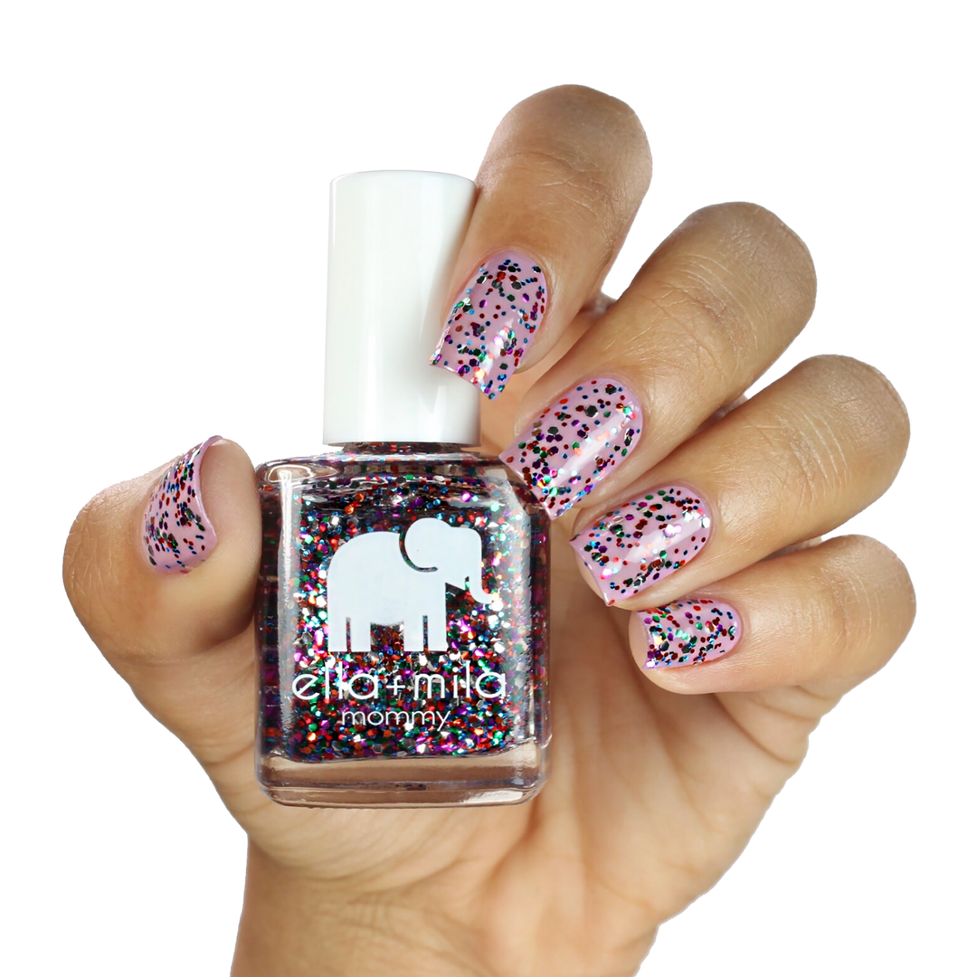 Party in a Bottle colorful glitter nail polish on a medium skin tone, hand holding the bottle