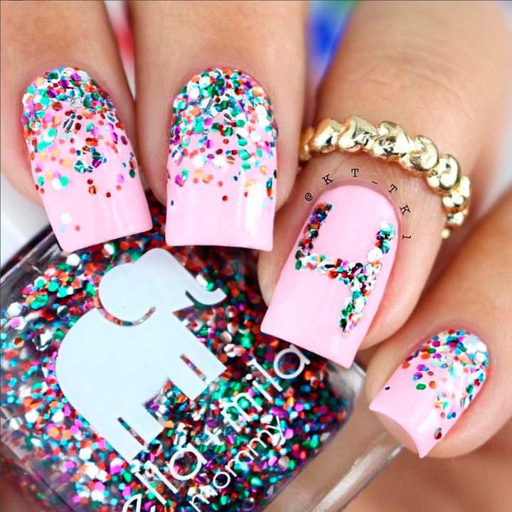 Party in a Bottle glitter gradient over pink nails with a gold ring