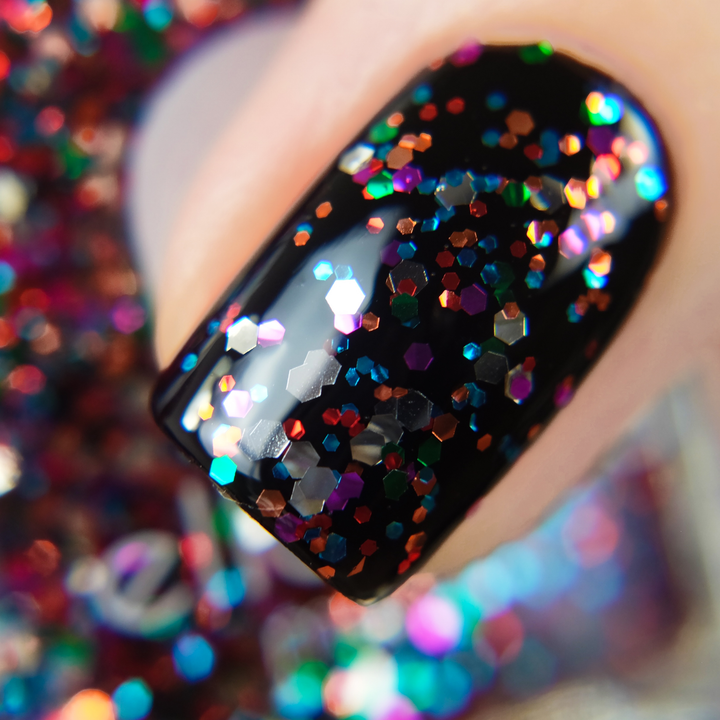 Party in a Bottle rainbow glitter nail polish close-up over black