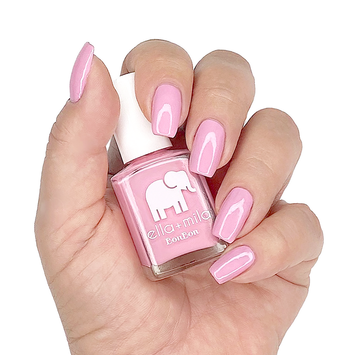 Pink Drink sweet light pink nail polish manicure on a light skin tone with the bottle