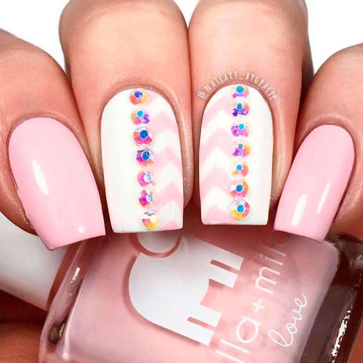 Pink Me Up baby pink nail polish with white and rhinestone heart accent nail art