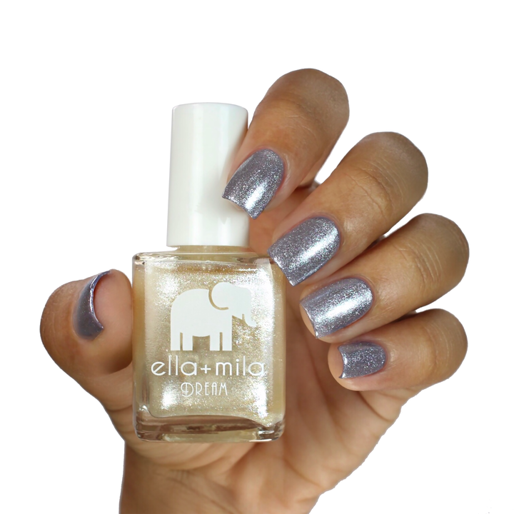 Pixie Dust frosted shimmer layered over grey nail polish, holding the bottle