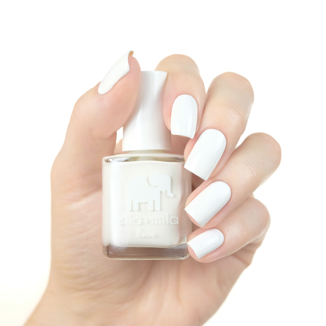 Pure Love pure white nail polish manicure on a light skin tone with the bottle