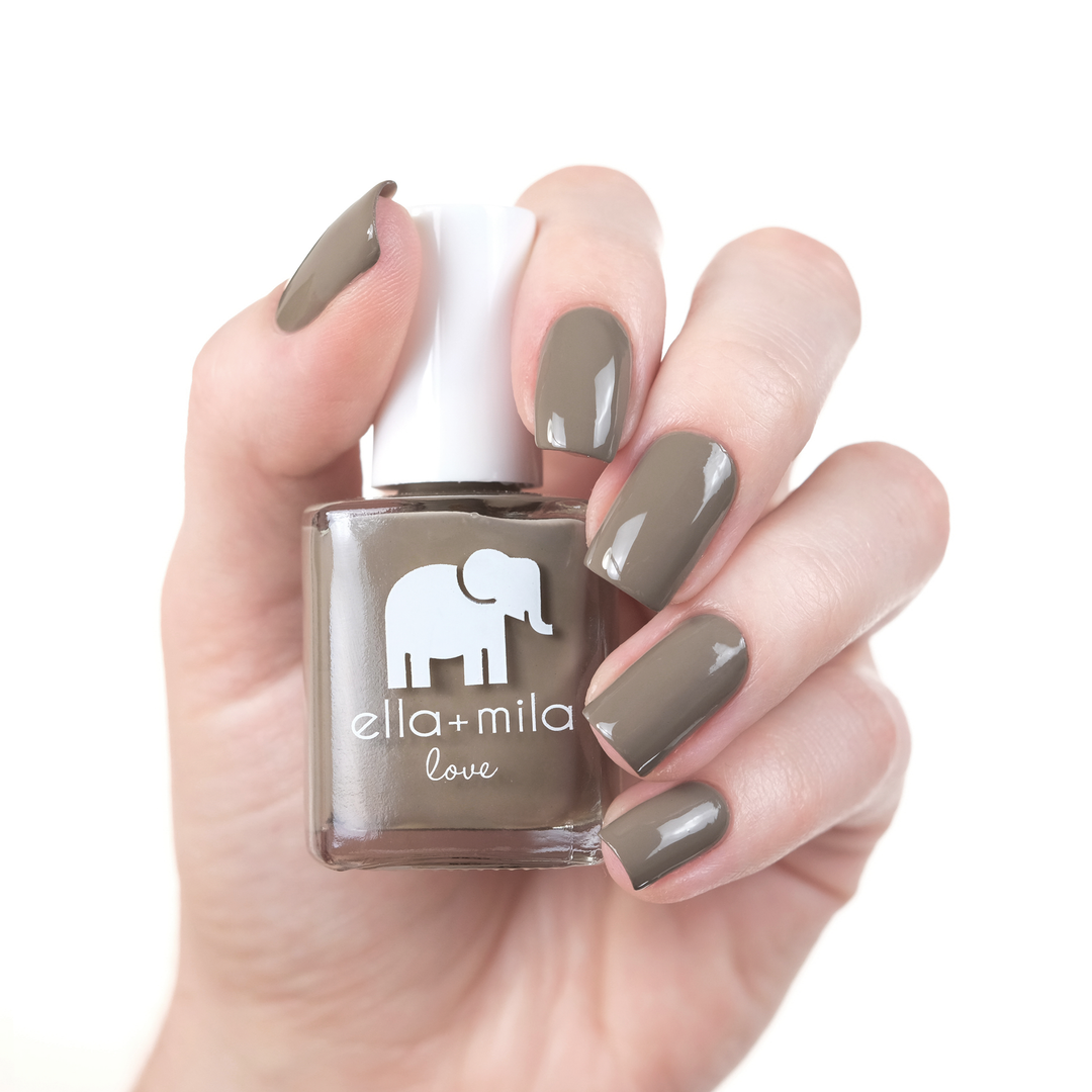 Sandstorm grey brown nail polish manicure on a light skin tone with the bottle