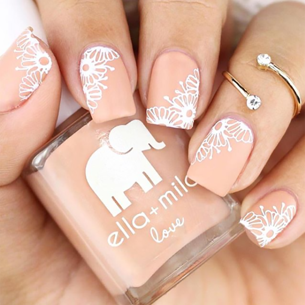 Sandy Toes nude nail polish with white lace and floral accent nail art