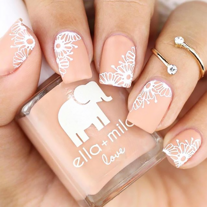 Sandy Toes nude nail polish with white lace and floral accent nail art
