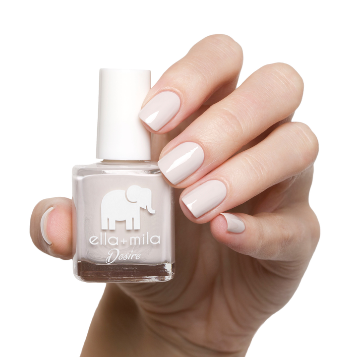 Stonehearted neutral grey nail polish manicure on a light skin tone with the bottle