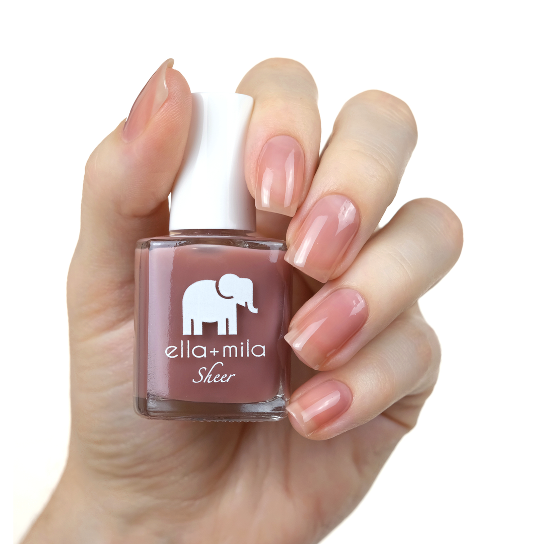Strong sheer brown mauve tint nail polish manicure on a light skin tone with the bottle