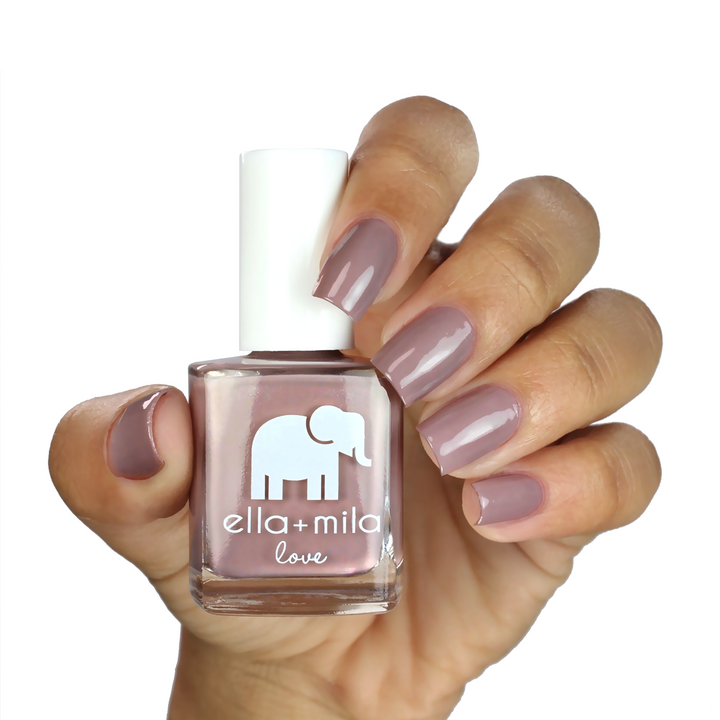 Sugar Fairy deep nude nail polish on a medium skin tone, hand holding the bottle