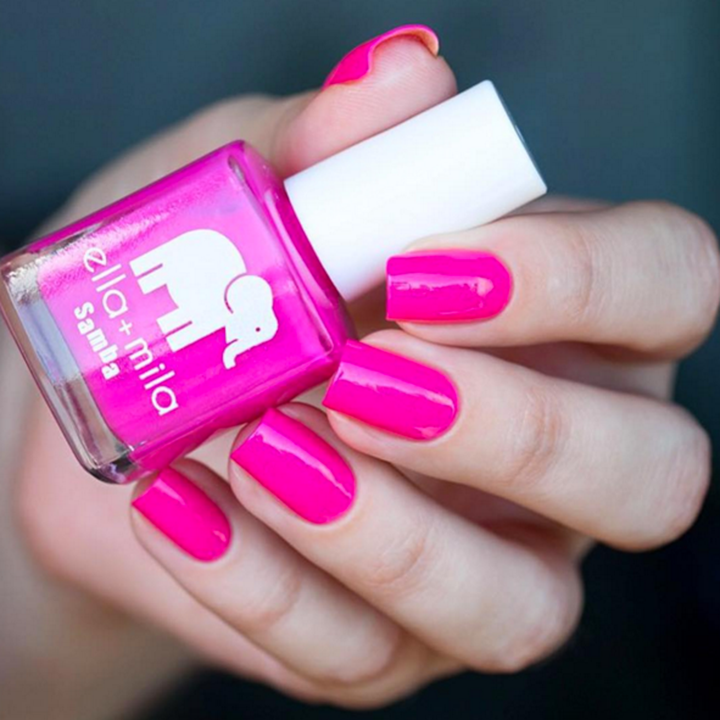 Sun Has Set hot purple-pink nail polish close-up manicure holding the bottle