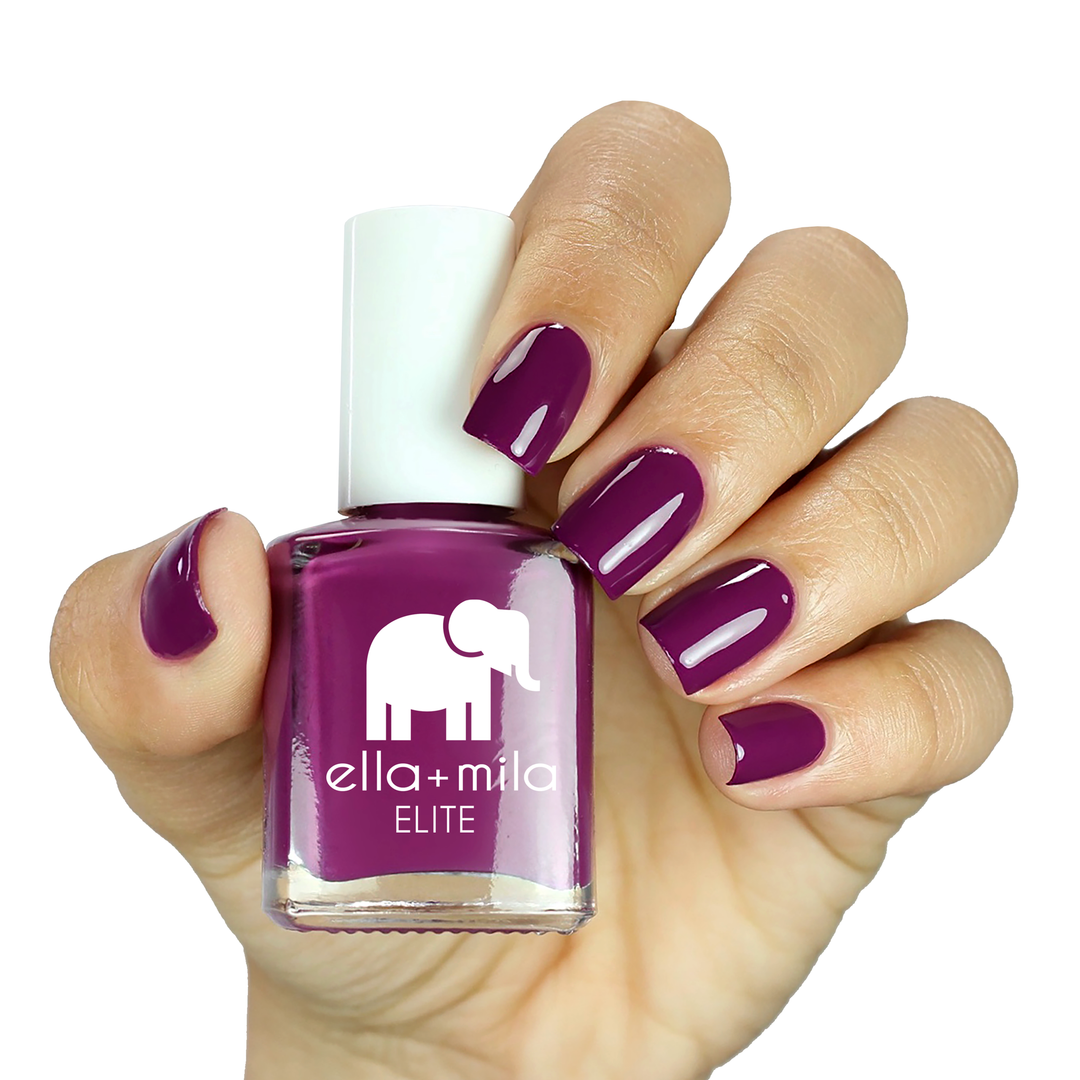 Take Off mauve berry nail polish on a medium skin tone, hand holding the bottle
