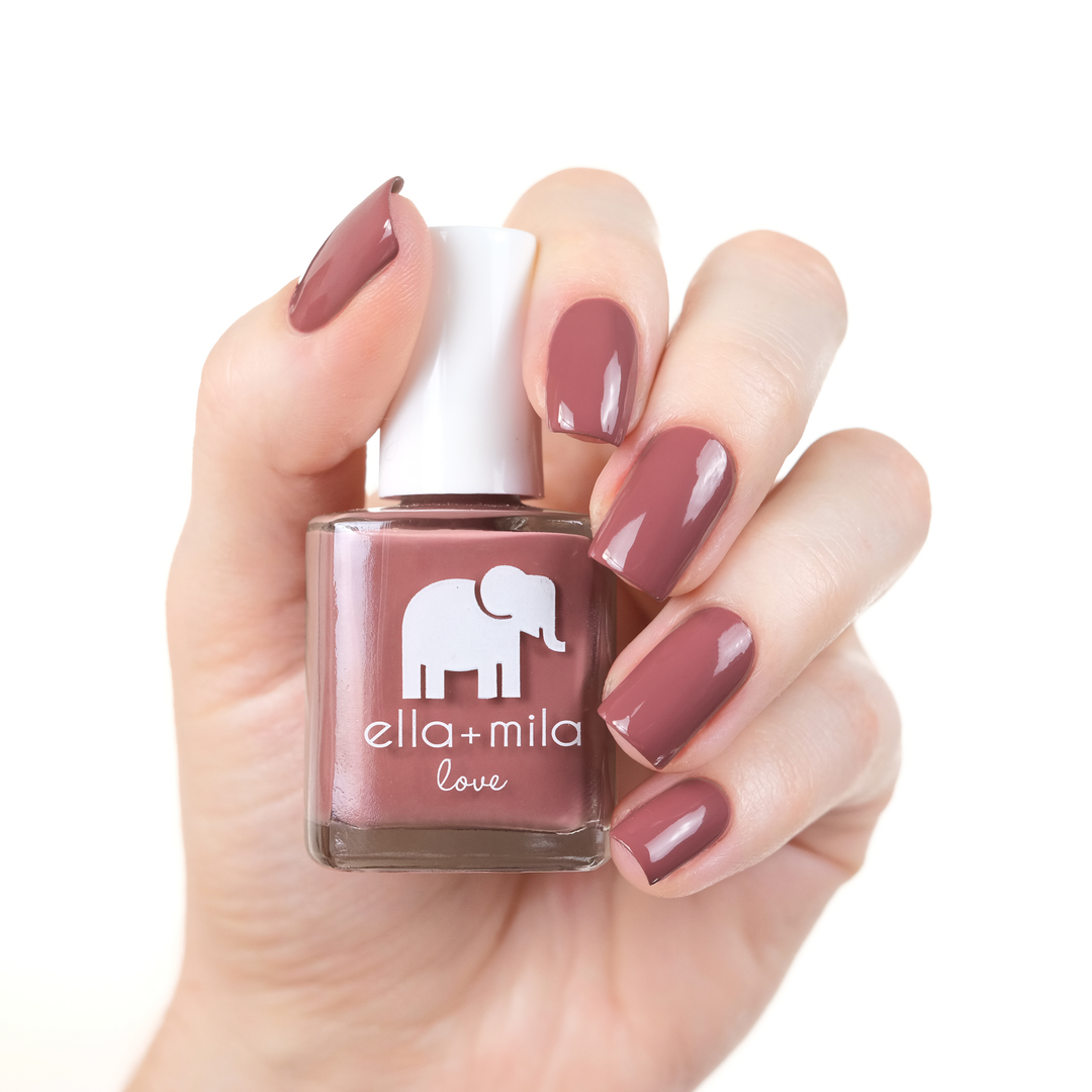 Til Forever rosy mauve nail polish manicure on a light skin tone with the bottle
