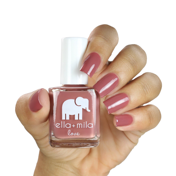 Til Forever pink brown mauve nail polish on a medium skin tone, hand holding the bottle
