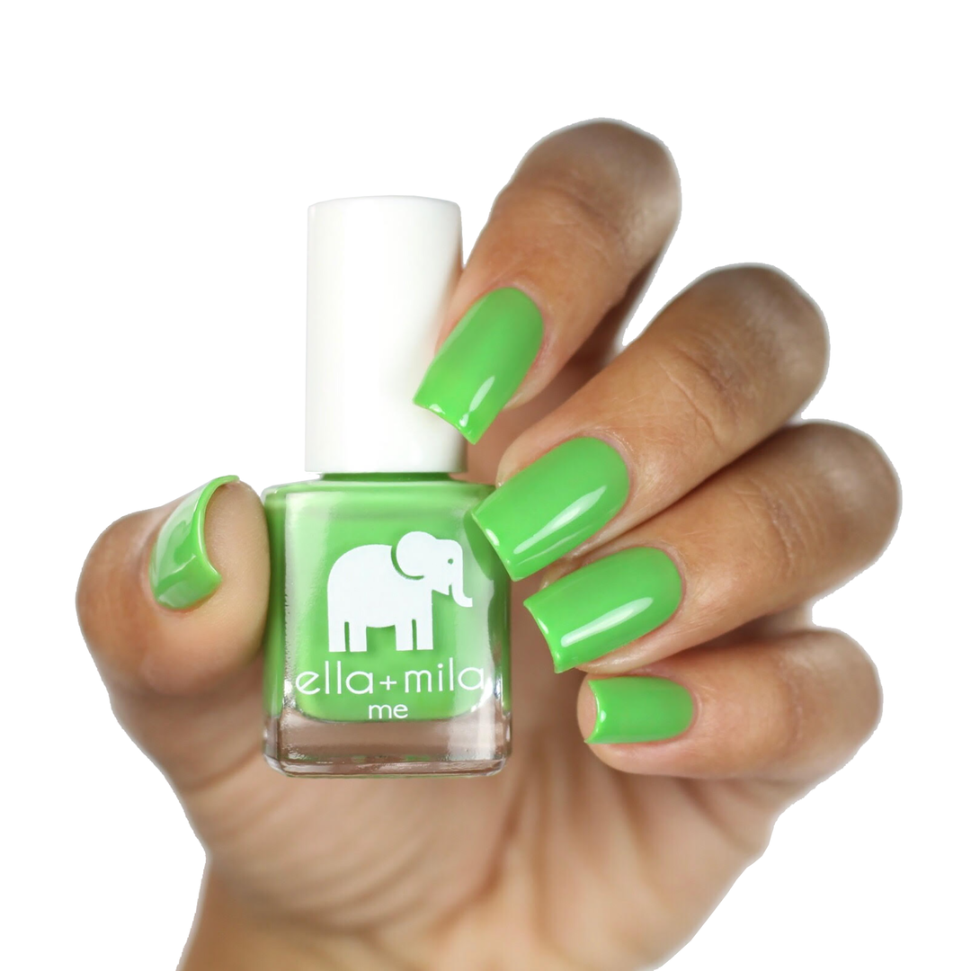 Tropical Jungle soft green nail polish on a deep skin tone, hand holding the bottle