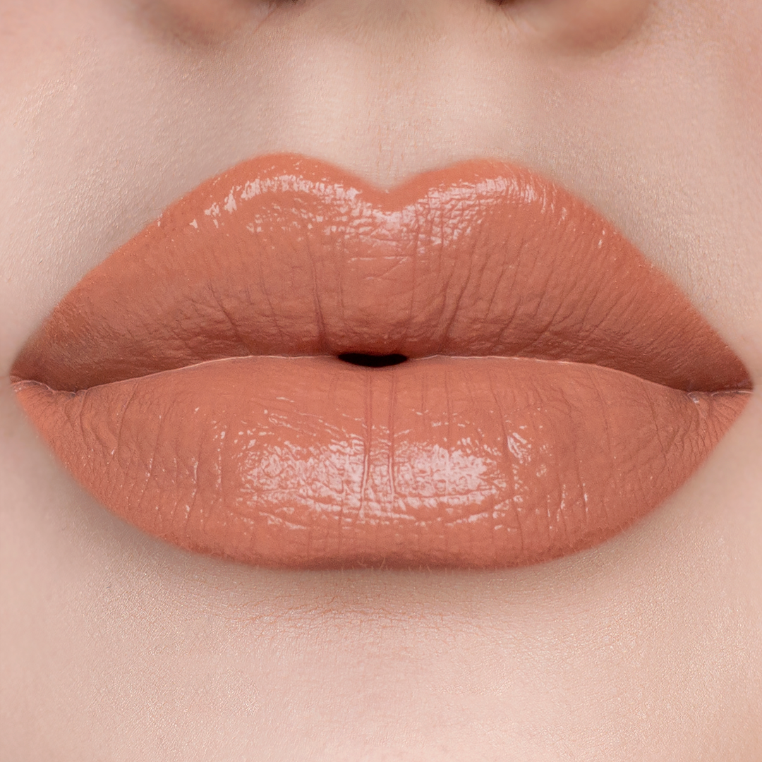 Twisted peachy nude lipstick on lips, light skin tone