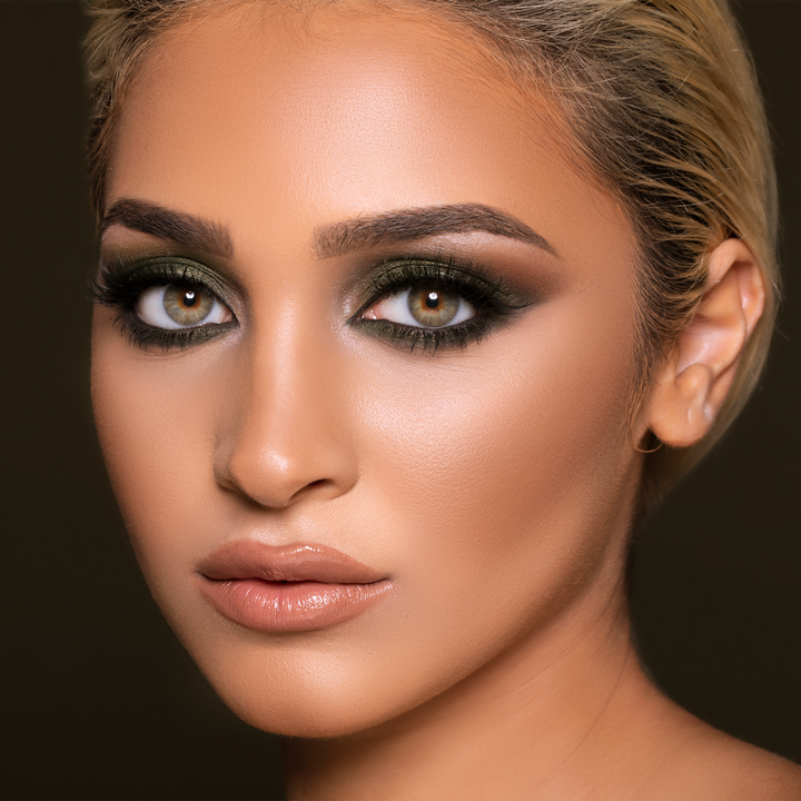 Model wearing Twisted peachy nude lipstick with a smoky eye and slicked-back hair