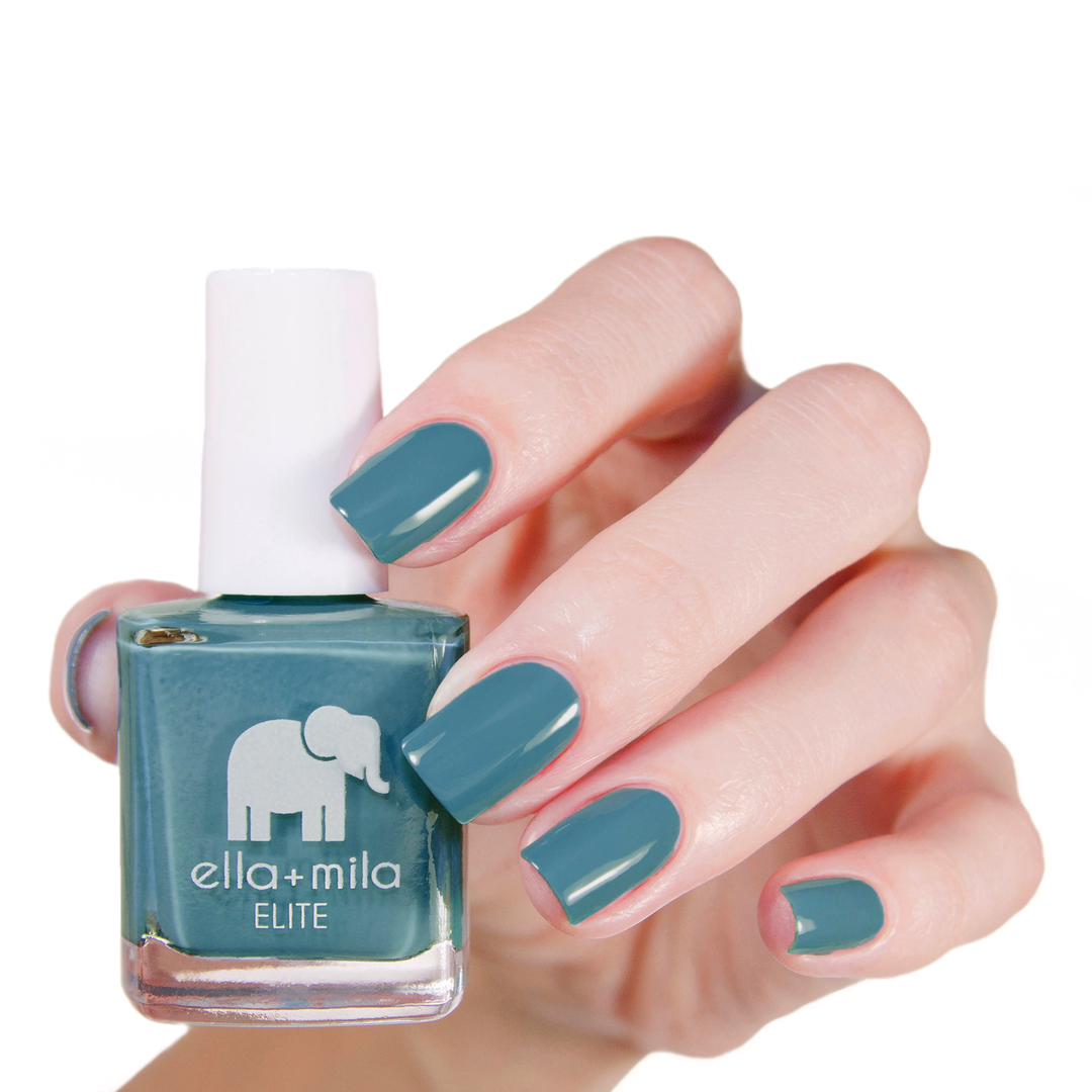 Under the Sea dark turquoise nail polish manicure on a light skin tone with the bottle