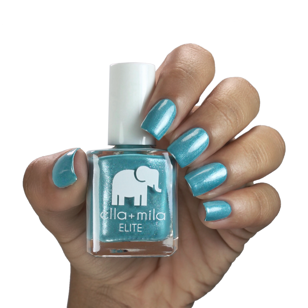 Under the Sea shimmery turquoise nail polish on a medium-deep skin tone, hand holding the bottle