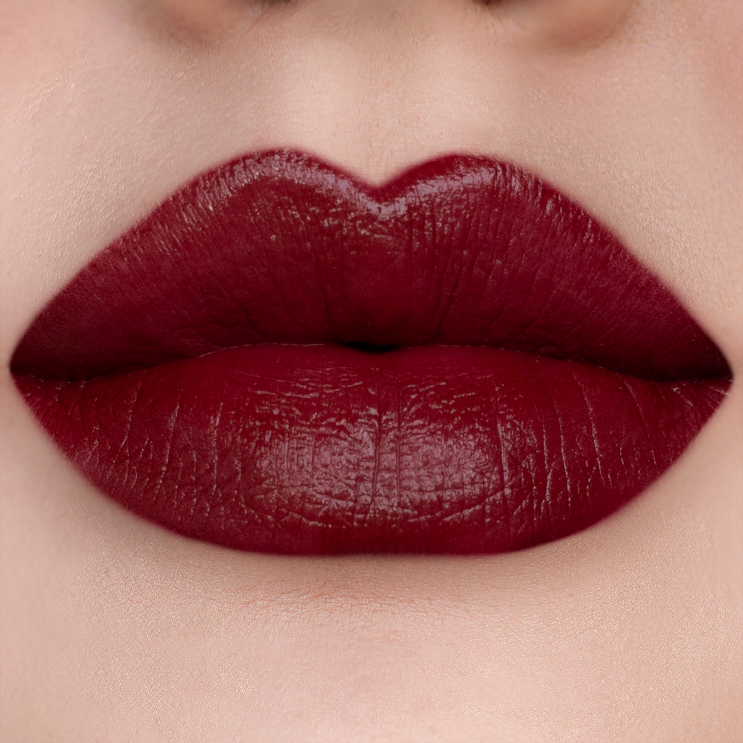 Vampy deep red lipstick on lips, light skin tone