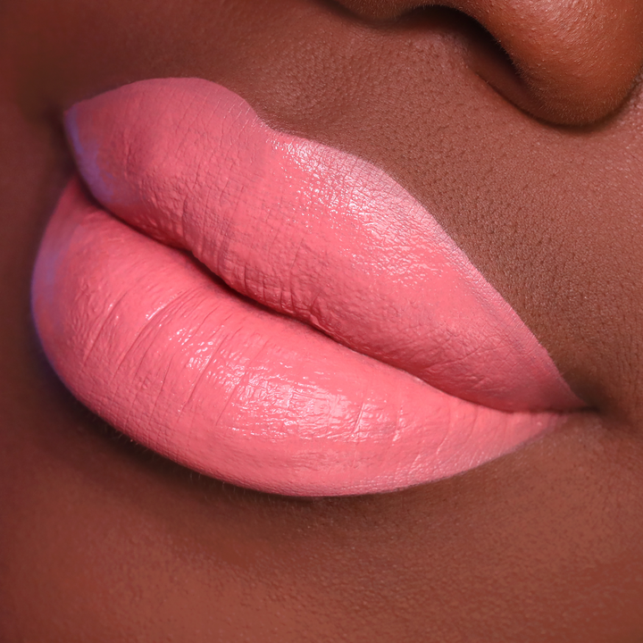 Your Muse rosy pink lipstick on lips, deep skin tone close-up